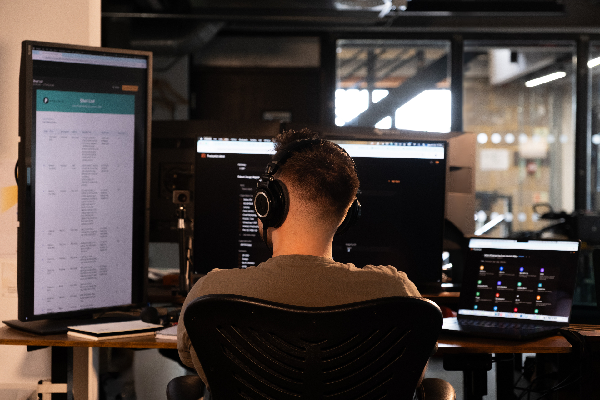 Film professional using Production Deck on a multi-monitor workstation